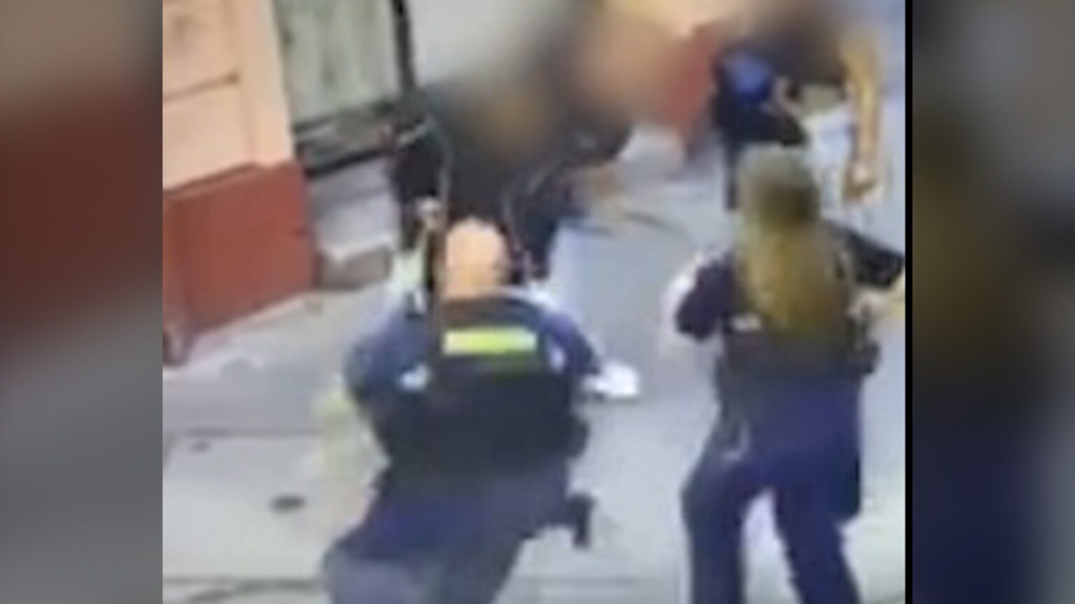 Két egyenruhás rendész intézkedik egy józsefvárosi utcán, a többi szereplő arca kitakarva